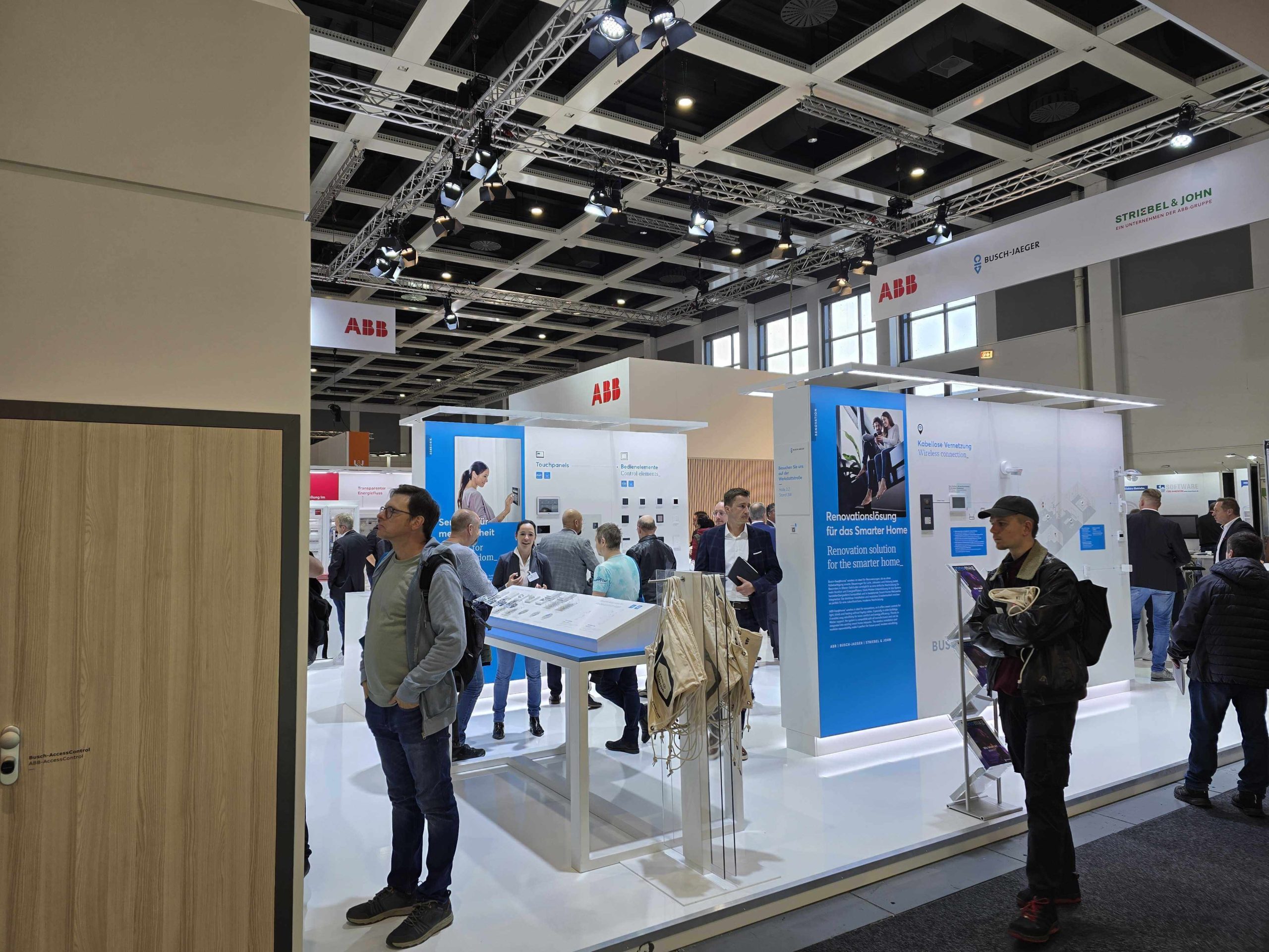 People using product demos at an ABB booth